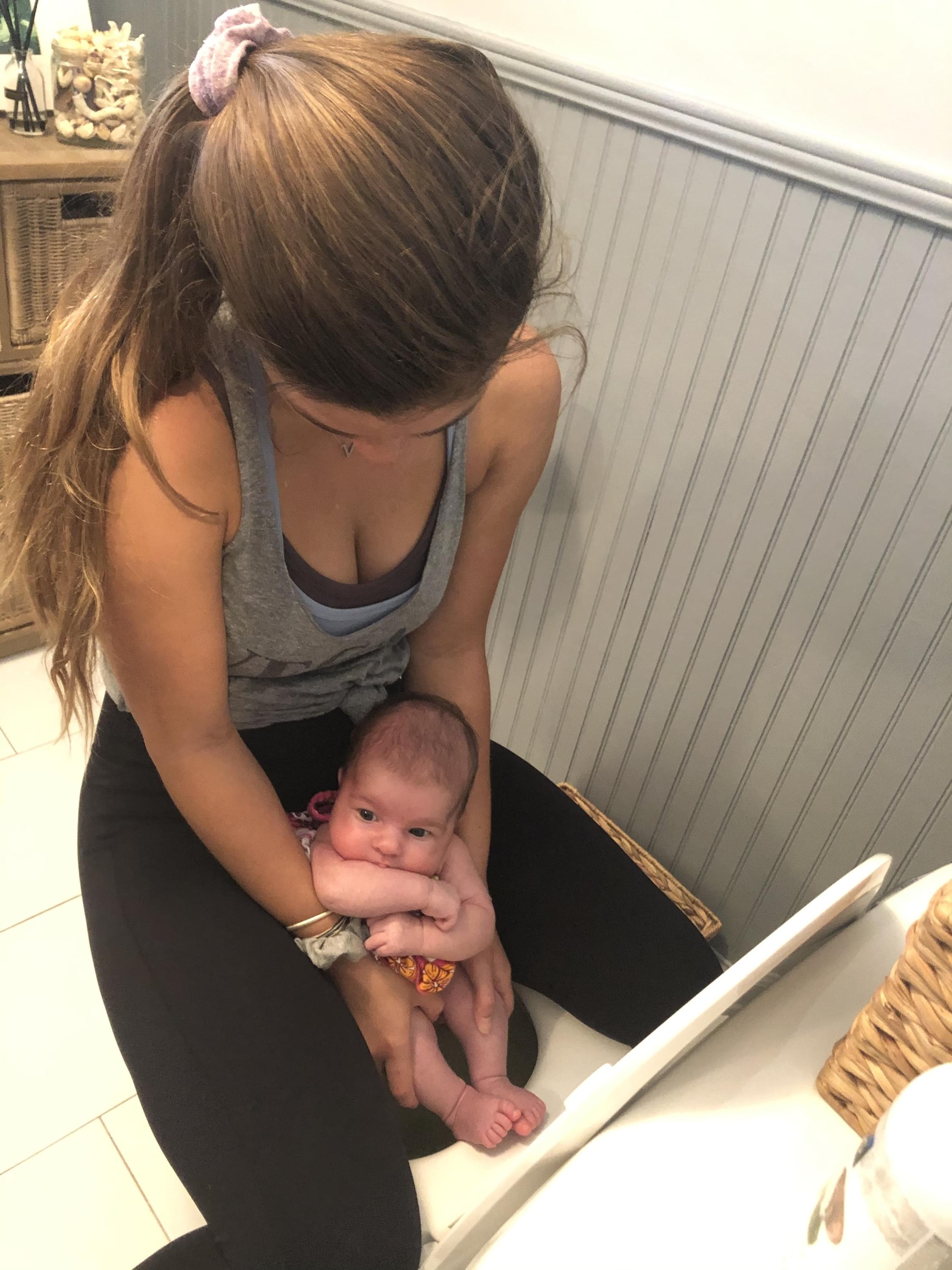 mama pottying baby over toilet
