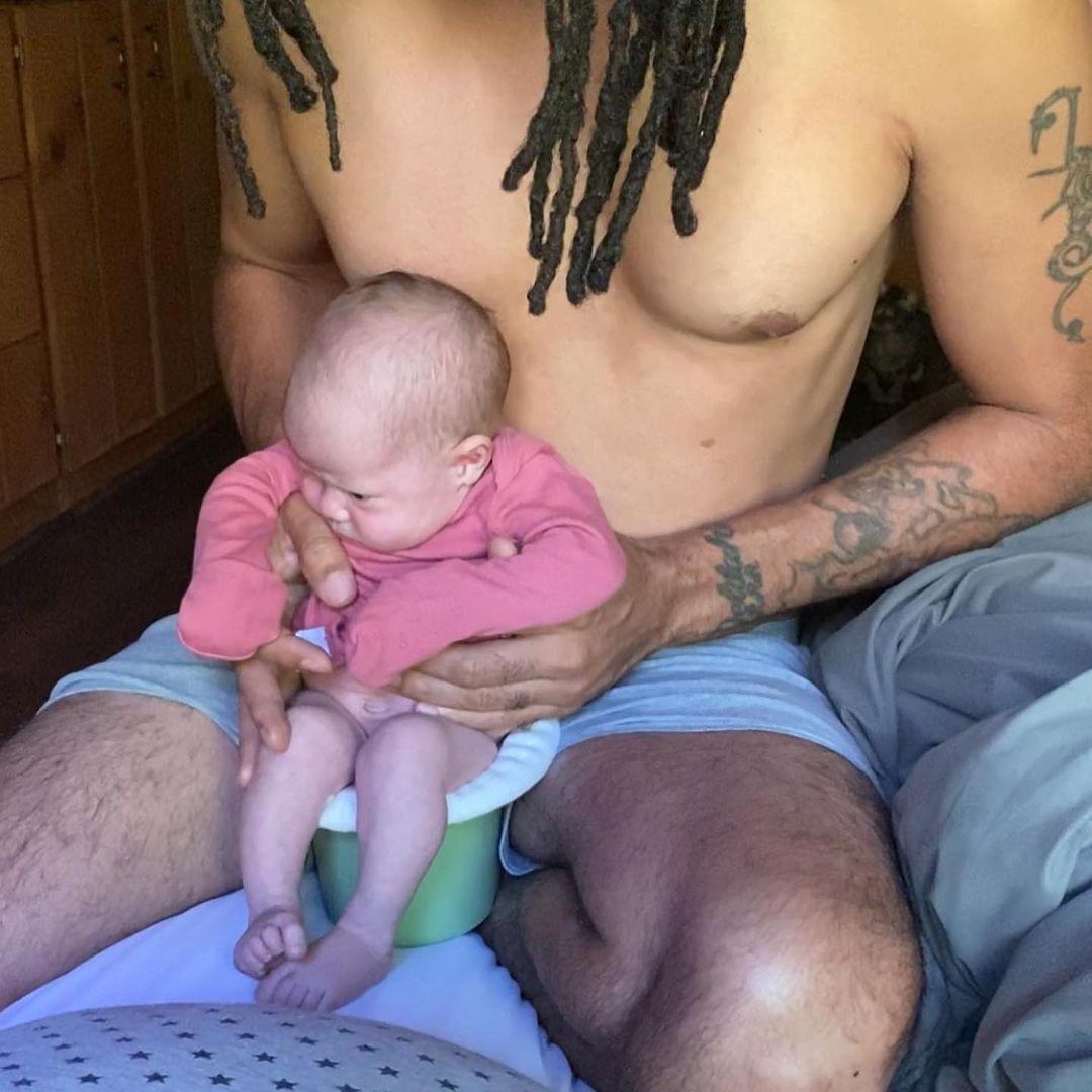 daddy pottying baby over toilet